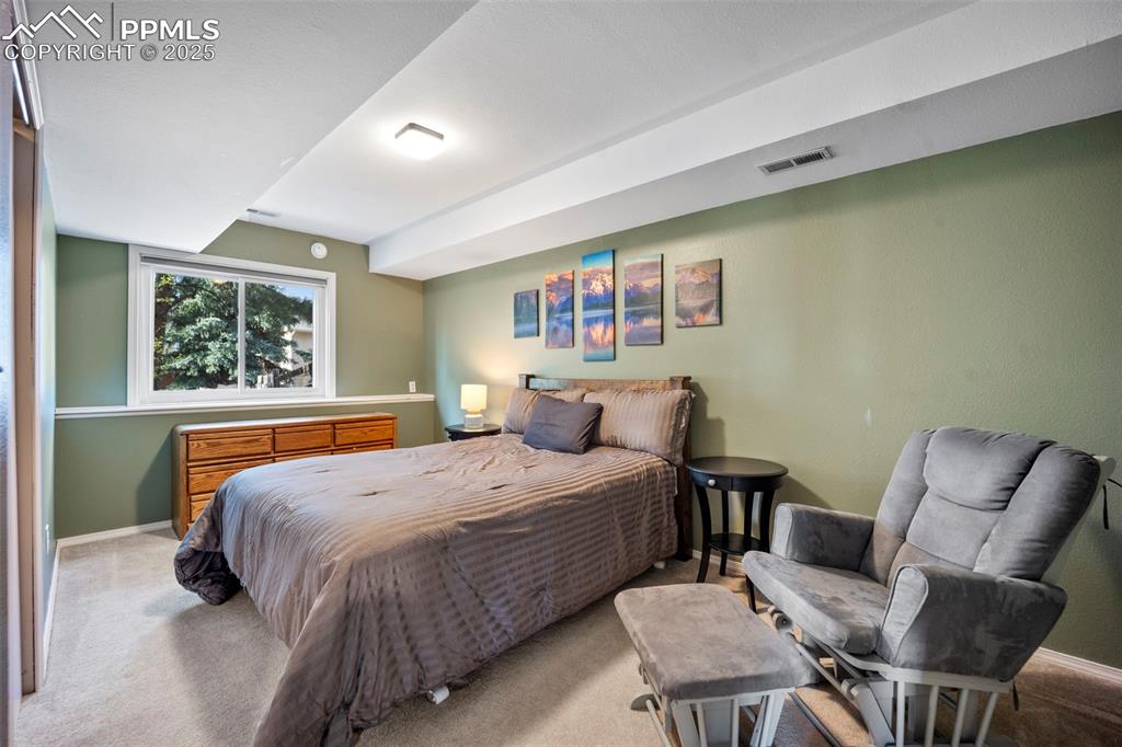 Carpeted bedroom with visible vents and baseboards