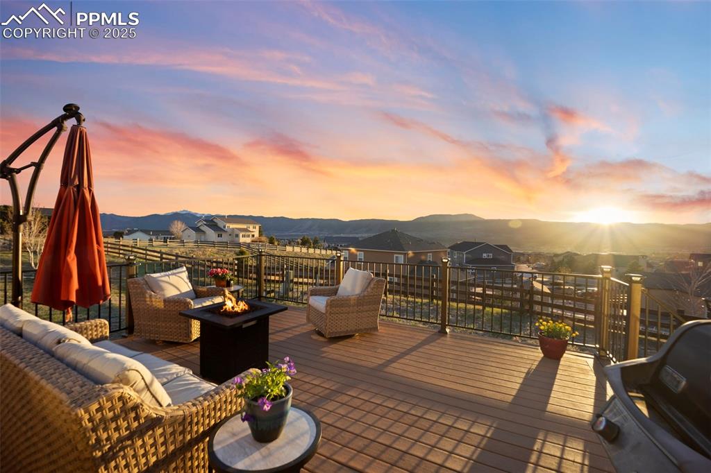 Deck with an outdoor living space with a fire pit and a mountain view