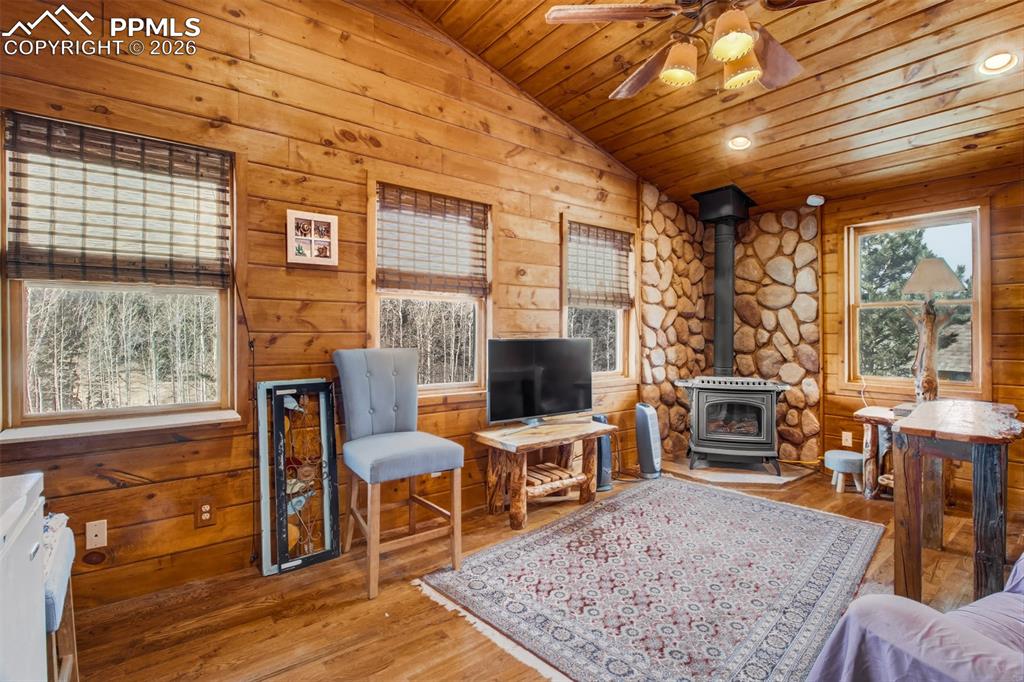 Sitting room off primary with gas burning stove, wood floors and wood accents throughout 