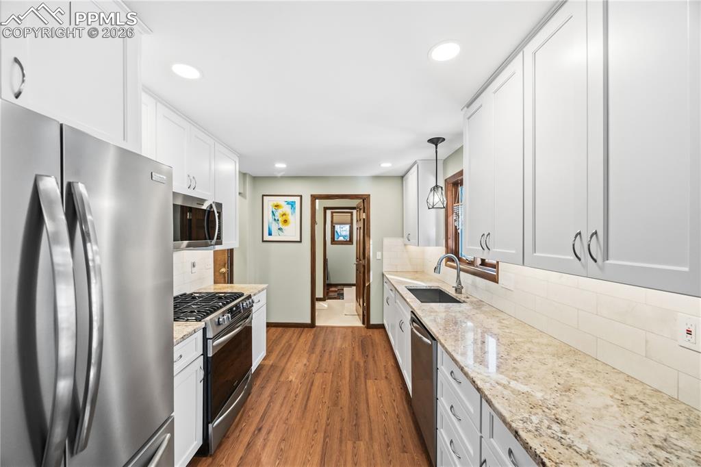 granite countertops, gas stove, under cabinet lighting, soft close doors