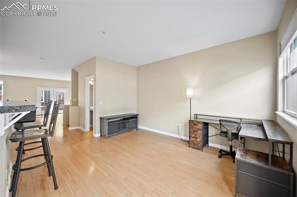 This area is being used as an office area.  Could be a sitting area, mount a TV and make wings and watch the game. 