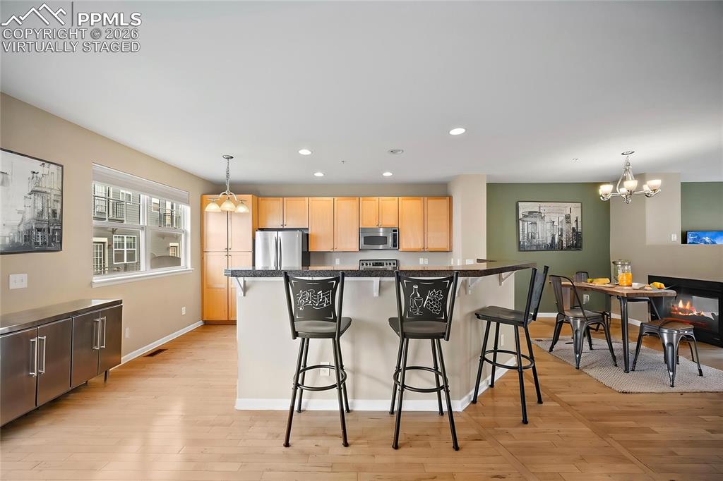 virtually staged - 3-sided Fireplace for the kitchen area and living.