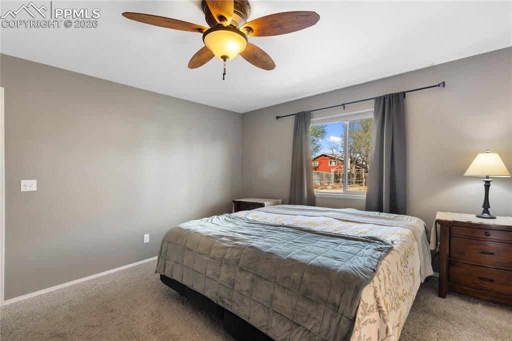 Bedroom with ceiling fan and carpet floors