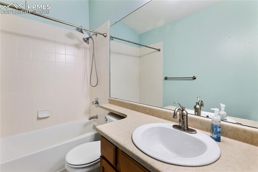 Full bath featuring vanity and  shower combination
