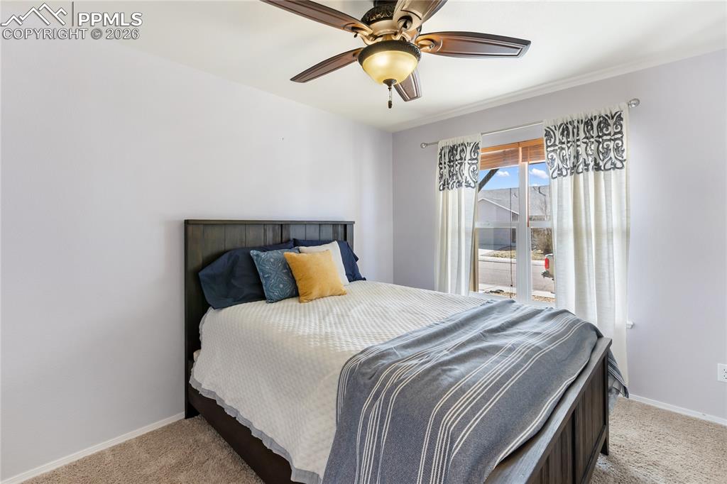 Bedroom featuring light carpet and ceiling fan