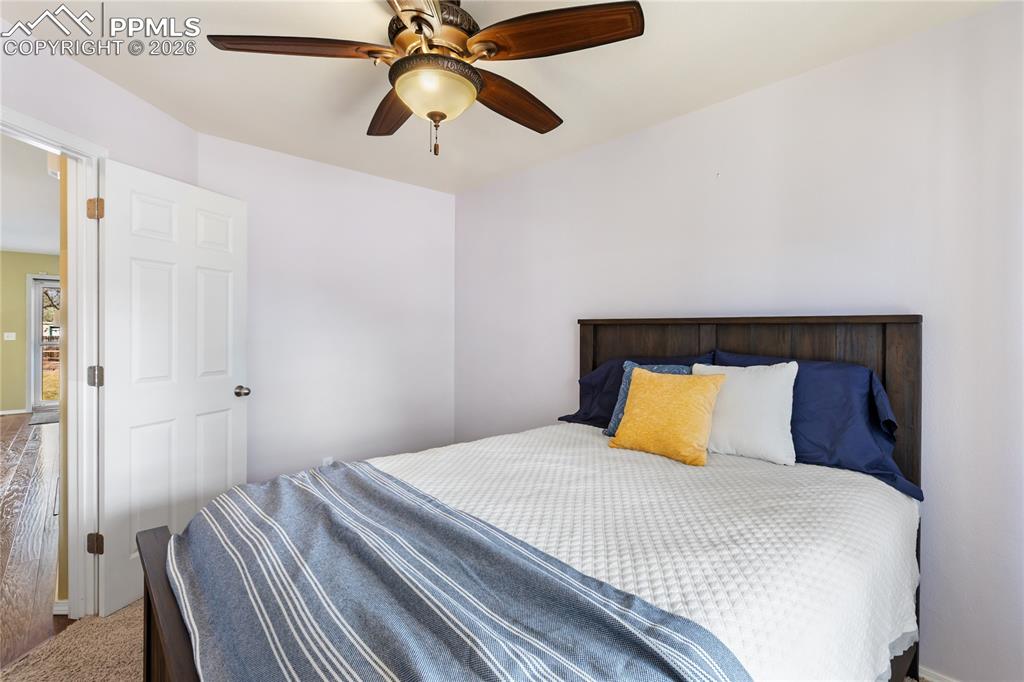 Bedroom featuring ceiling fan and baseboards