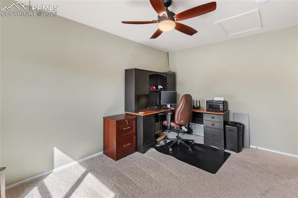 Office area featuring a ceiling fan and carpet flooring