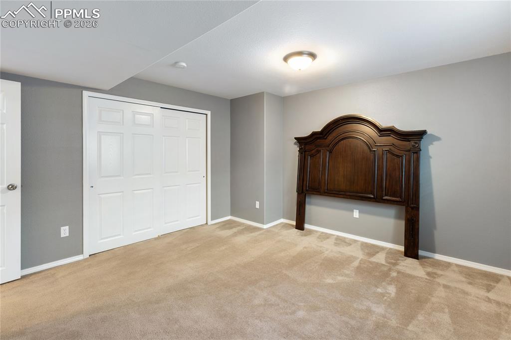 Unfurnished bedroom with a closet and light colored carpet