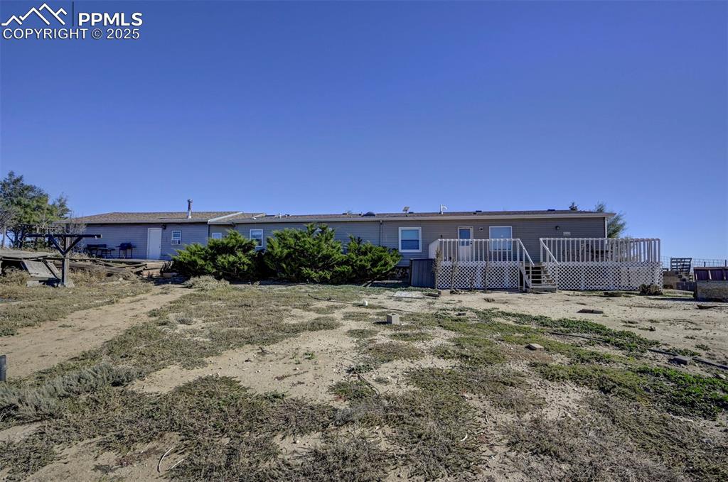 Back of property with a wooden deck