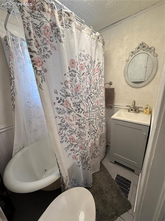 Full bath featuring a vanity, and shower / bathtub combination with curtain
