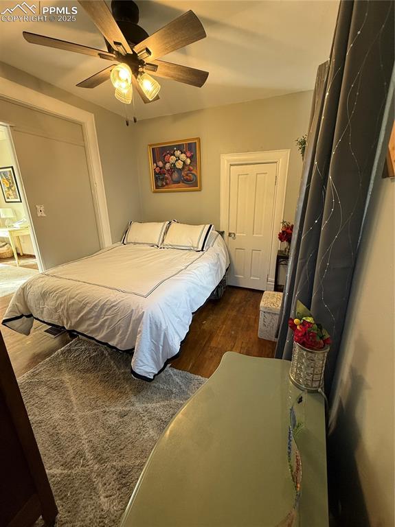 Bedroom featuring dark wood-type flooring and ceiling fan