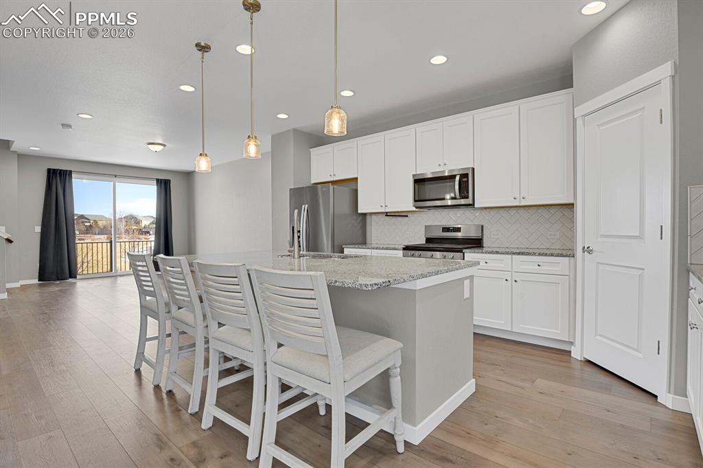 Kitchen with white cabinets and Pantry 