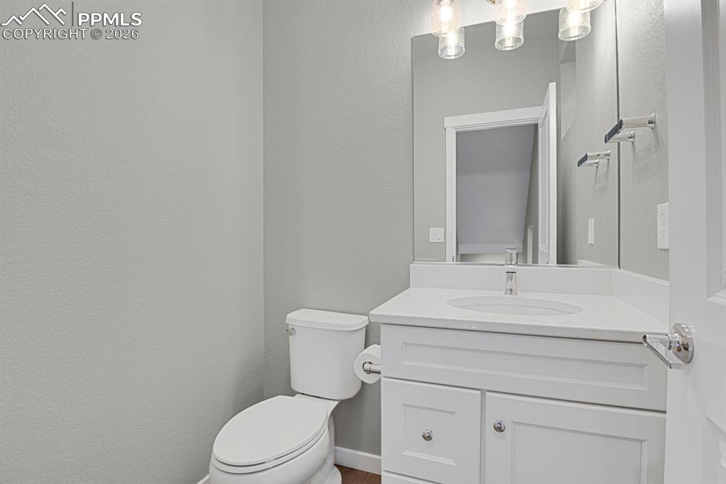 Bathroom with vanity and a textured wall