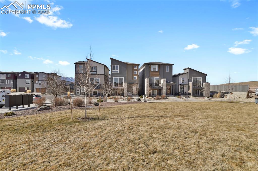 View of home's community featuring a residential view and a lawn