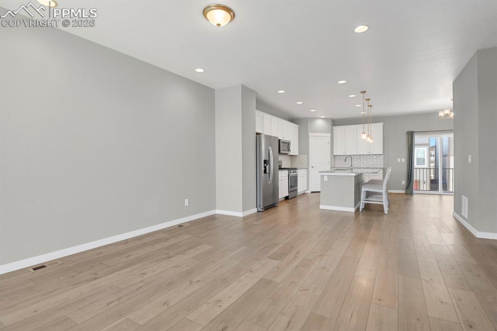 Unfurnished living room featuring recessed lighting and light wood-style flooring