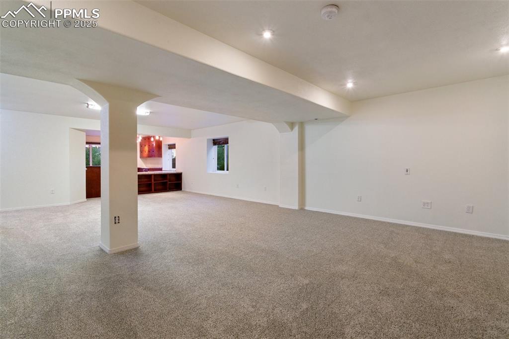 Basement with light colored carpet and recessed lighting