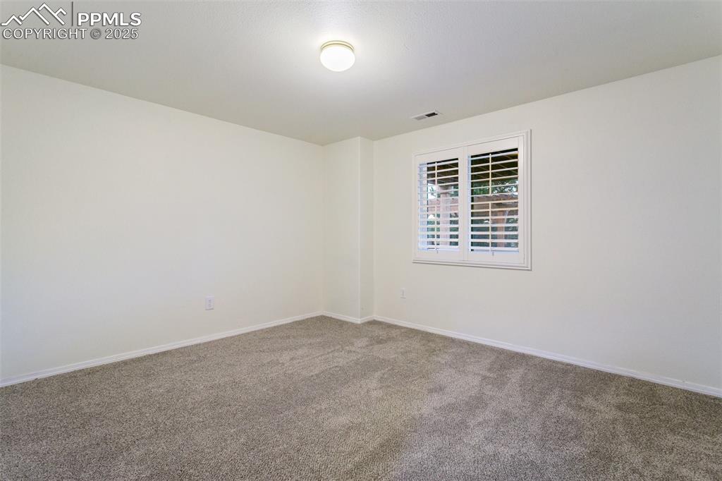 Empty room featuring carpet floors and baseboards