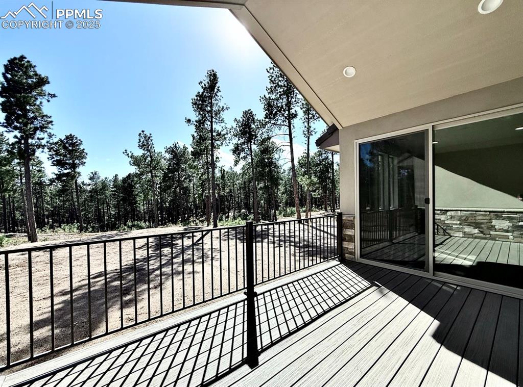 Oversized Sliding Doors to the Covered Composite Deck, featuring a Natural Gas line for Grilling and a Hose Bib for watering your favorite plants as you enjoy the forested surroundings.