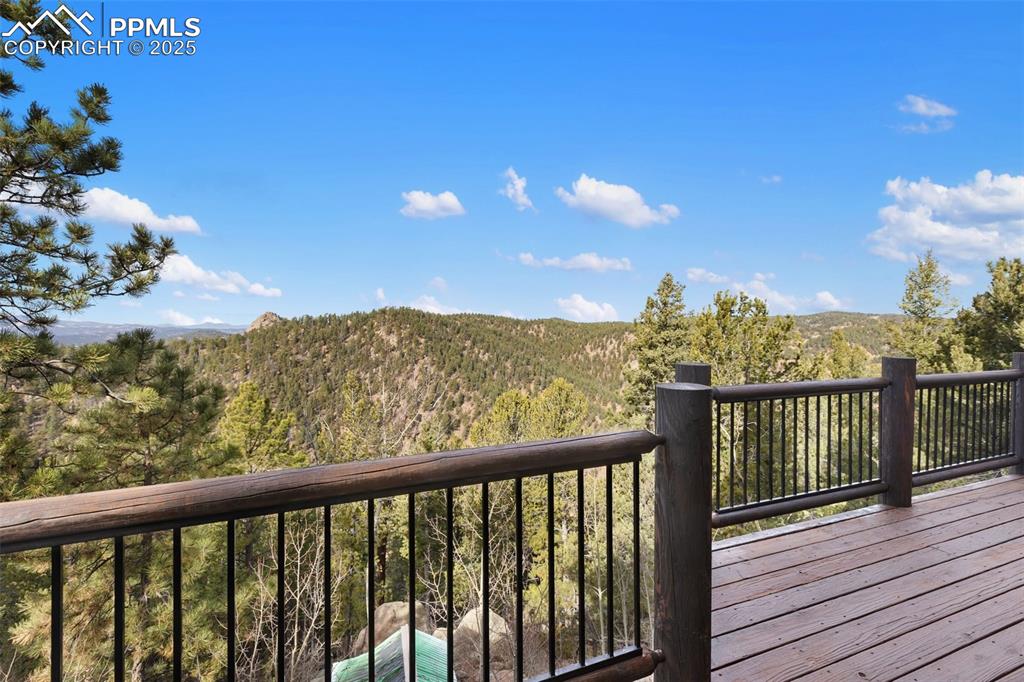 Deck featuring a view of trees and a mountain view