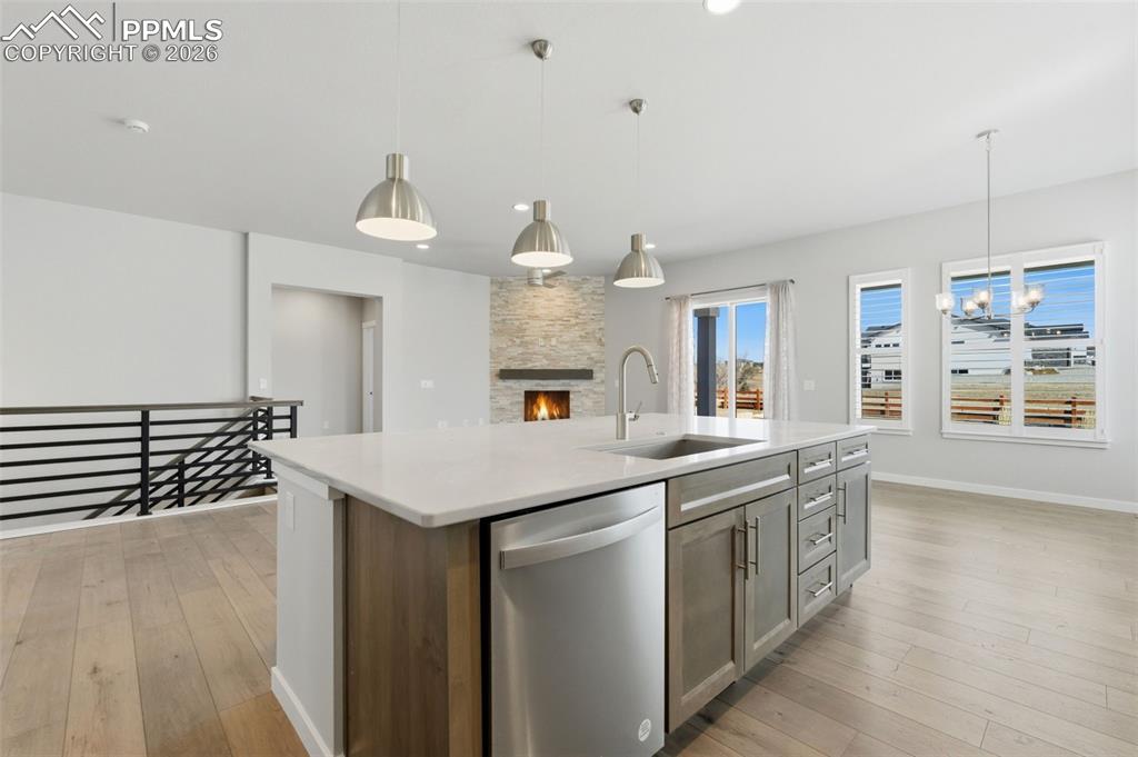 Stunning kitchen with pendant lighting over island, quartz countertops, and views to the mountains