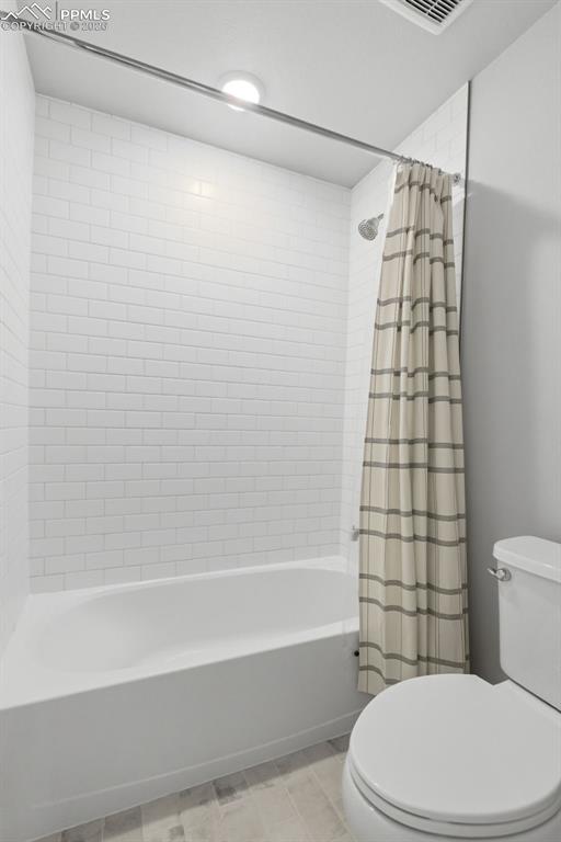 Basement 3/4 bathroom with walk-in shower featuring tile surround and modern fixtures