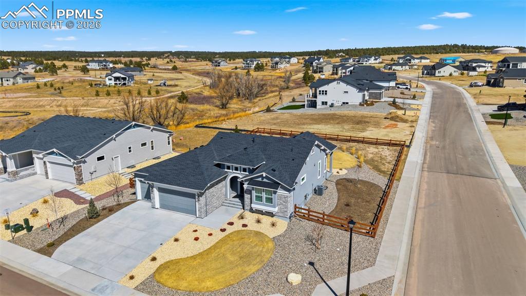 Aerial view showing property and surrounding community with stunning Colorado mountain range backdrop