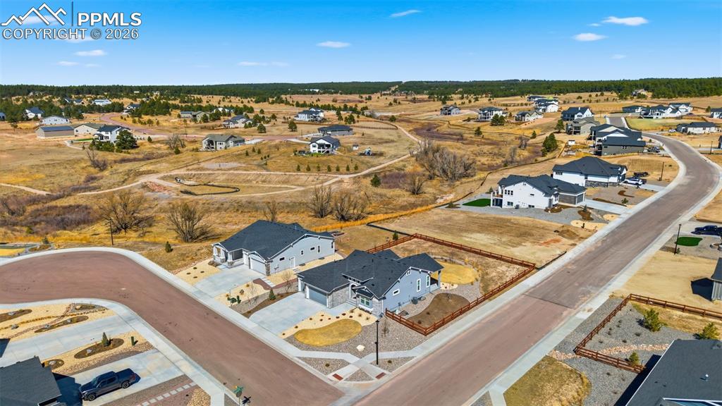 Wide aerial perspective of the property and neighborhood with sweeping mountain and valley views
