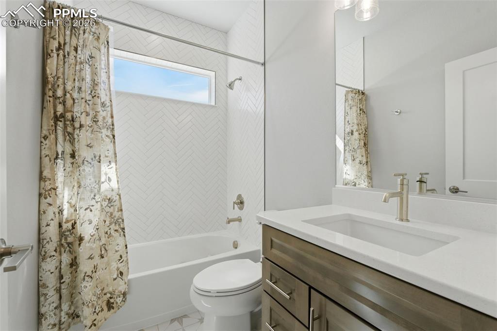 Elegant bathroom with decorative tile work, floating vanity with dual sinks, and large window