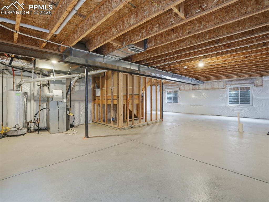 Below grade area featuring gas water heater and heating unit
