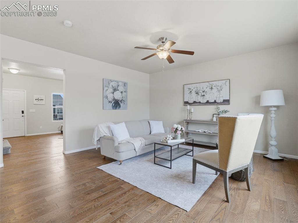 Living room featuring light wood-style flooring and ceiling fan