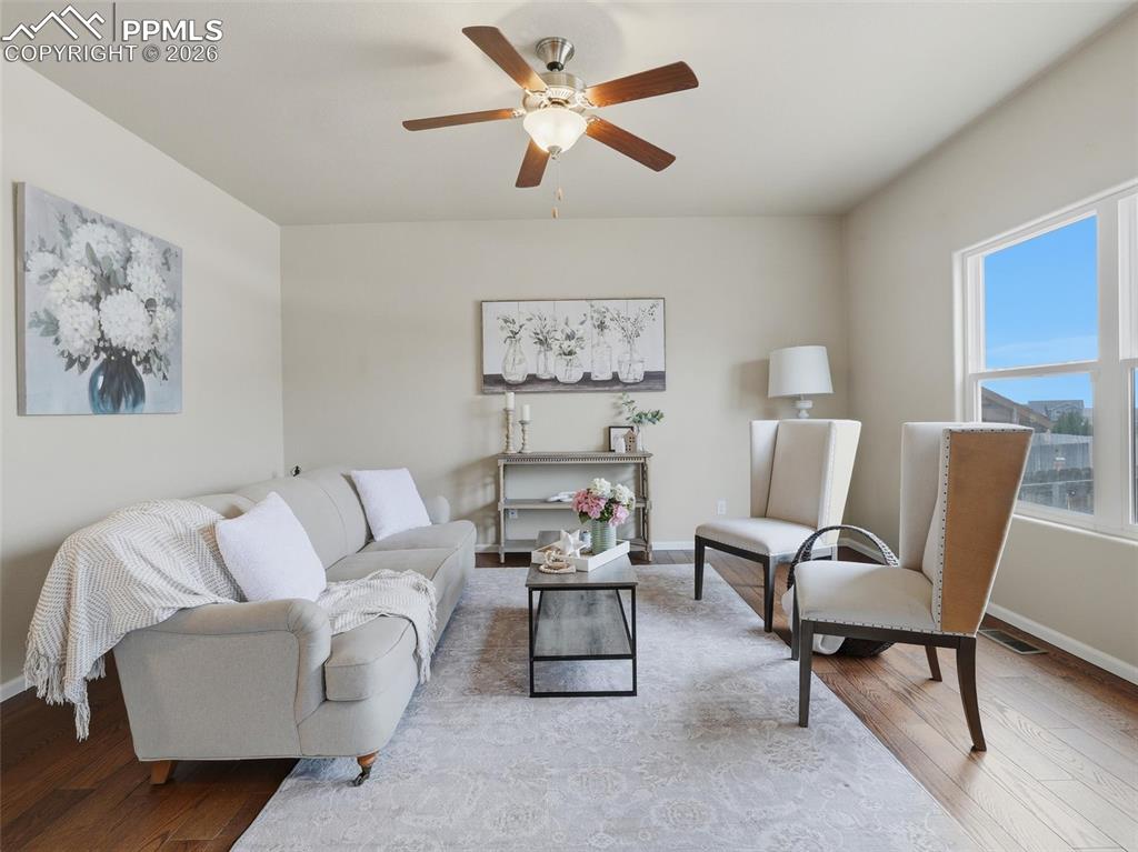 Living room featuring wood finished floors and ceiling fan