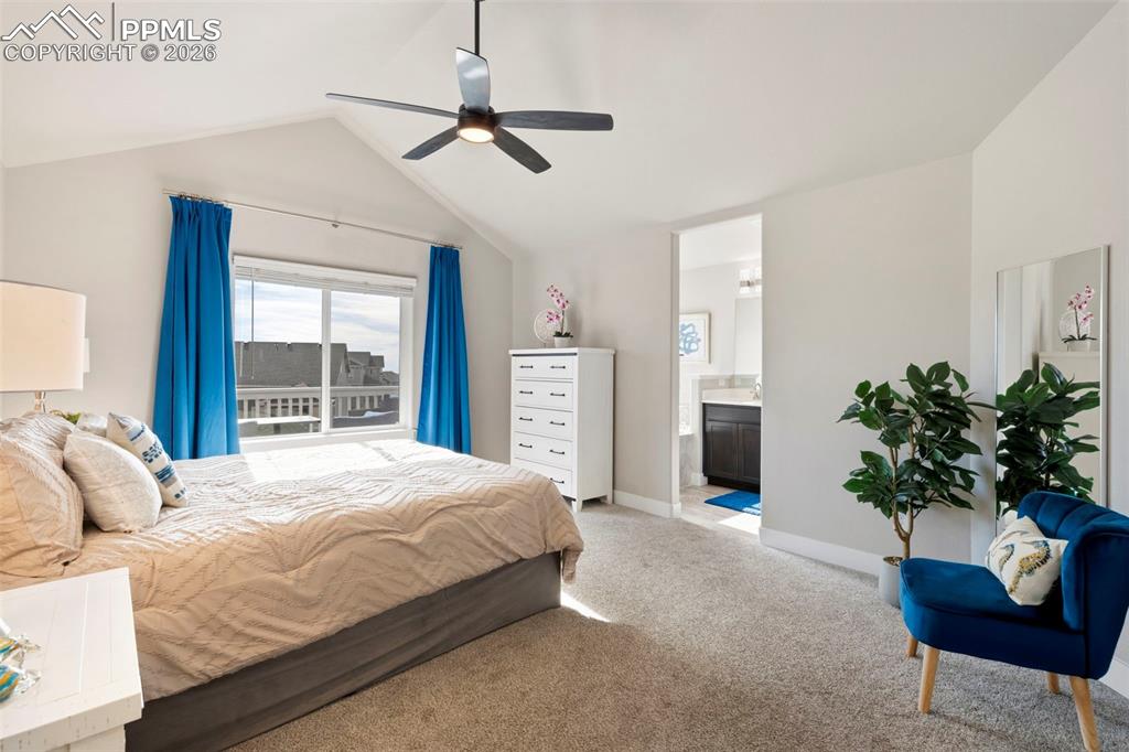 Bedroom featuring carpet, vaulted ceiling, and ceiling fan