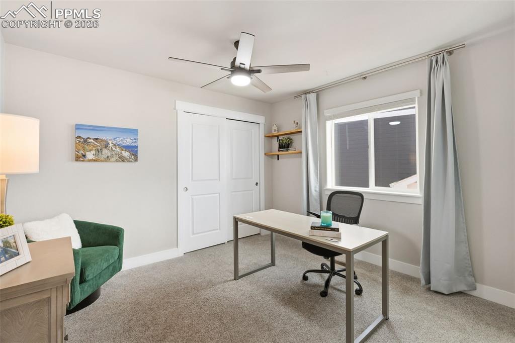 Office featuring light carpet and a ceiling fan
