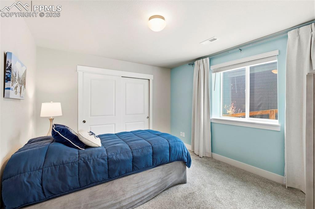 Bedroom featuring carpet floors and a closet