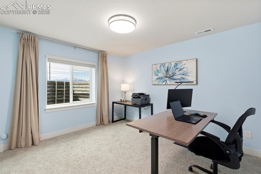 Office with light carpet and baseboards