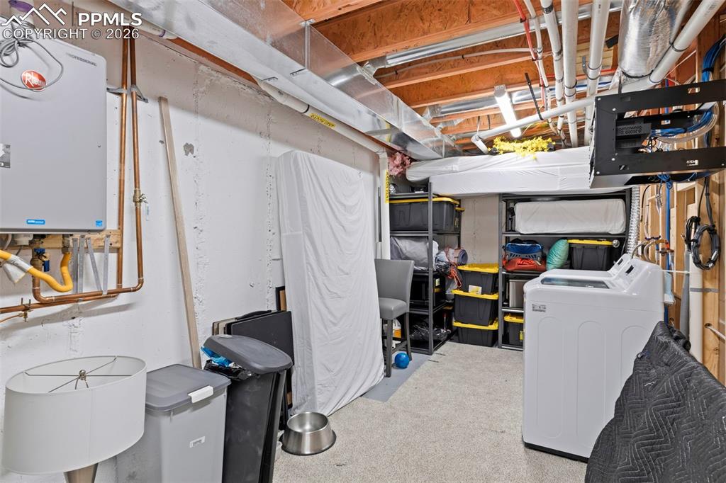 Unfinished basement with tankless water heater and separate washer and dryer - 2nd in home.