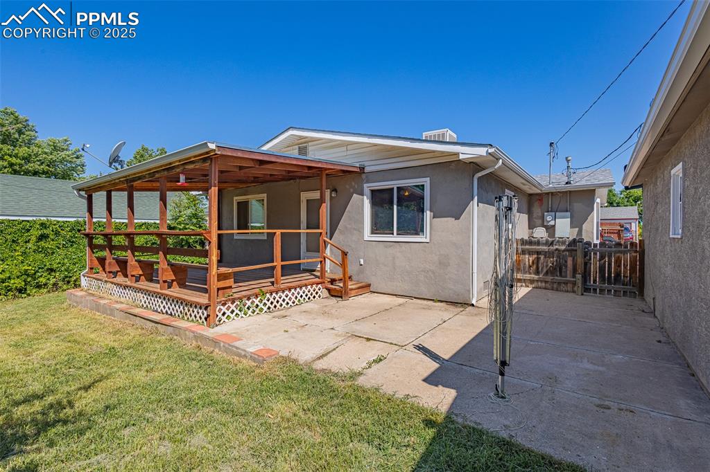 Back of house featuring a deck, stucco siding, and a patio area