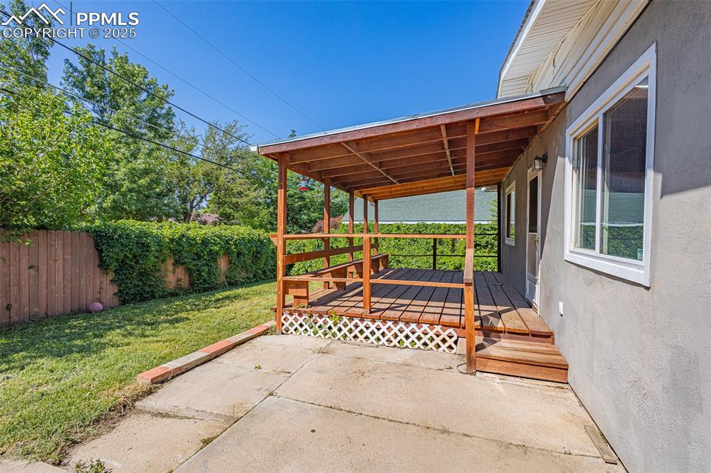 View of patio with a wooden deck