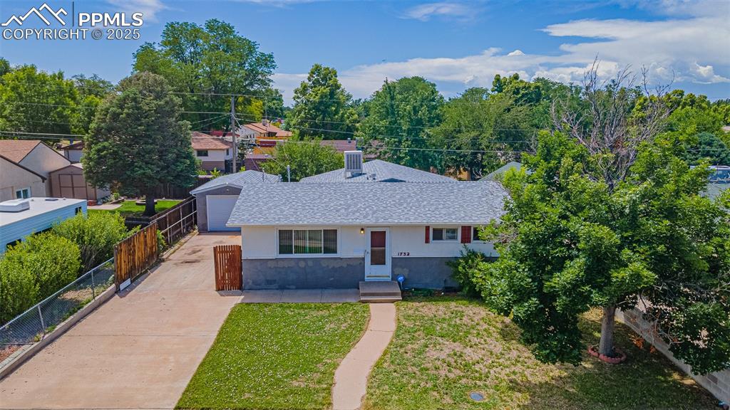 View of front of property featuring a shingled roof and driveway