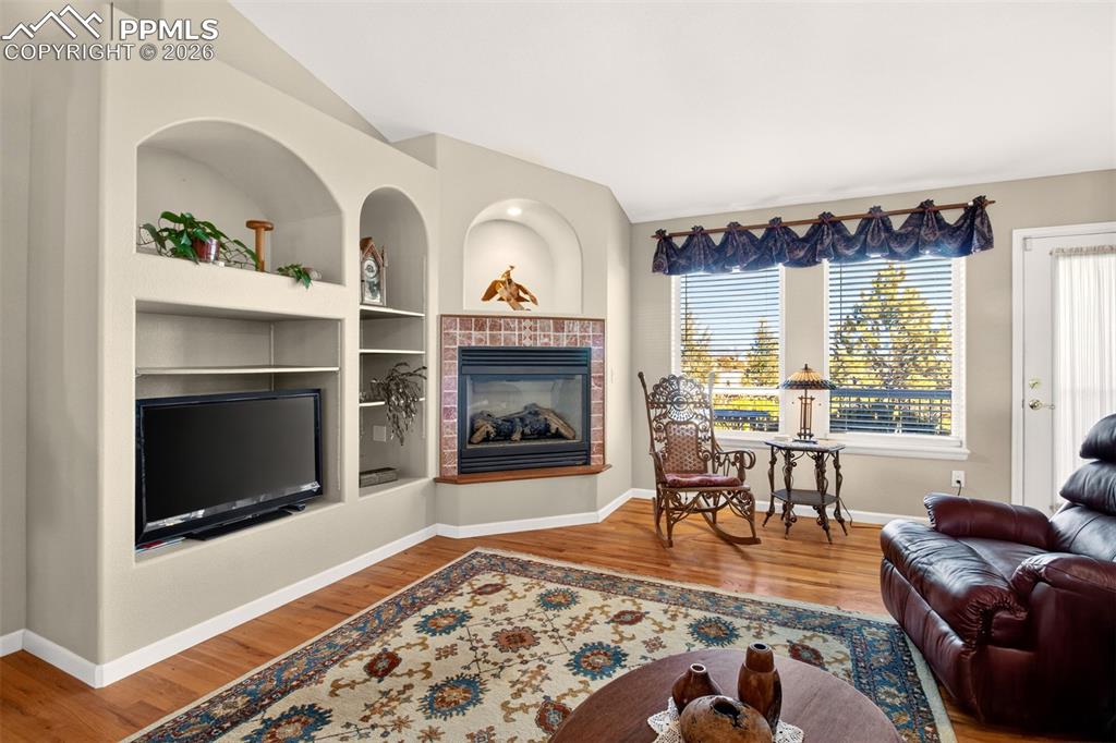 Generous Living Room With Built-In Niches Overlooking The Private Backyard.