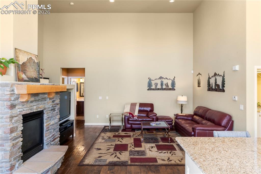 Living room with gas fireplace and stacked stone surround. 