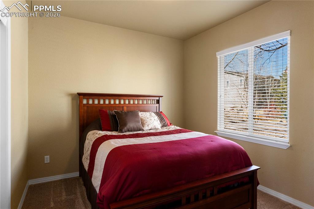 Main level guest bedroom with carpet. 