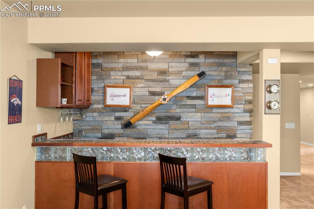 Wet bar with stacked stone feature wall. 