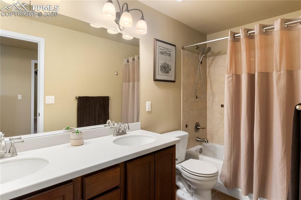 Basement full bath with double vanity. 