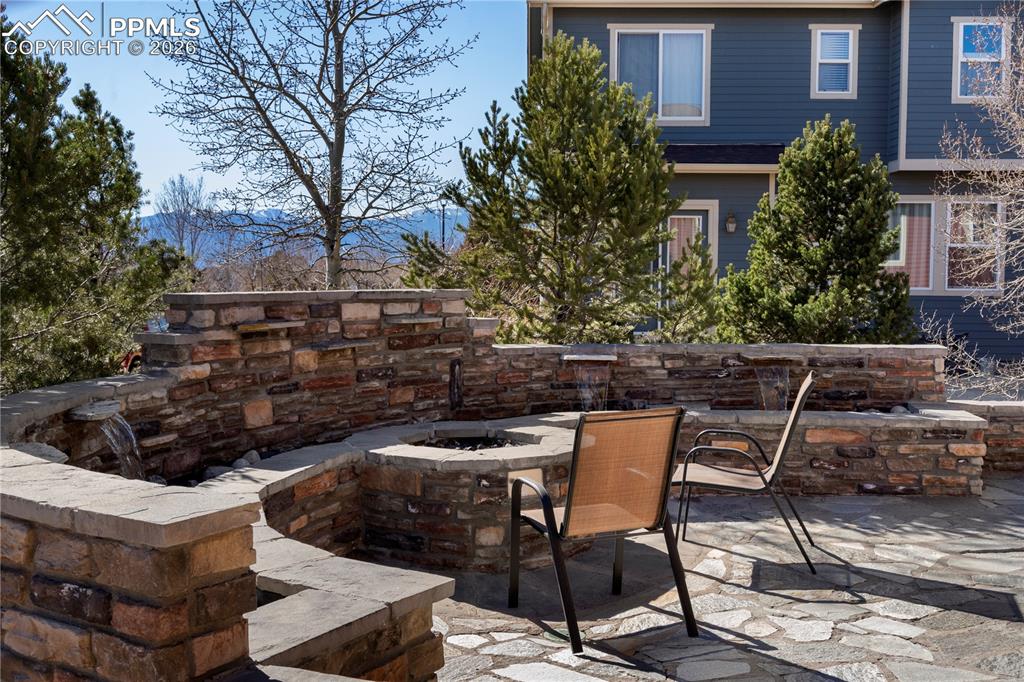 Gorgeous back patio with firepit, water feature and stunning mountain views.