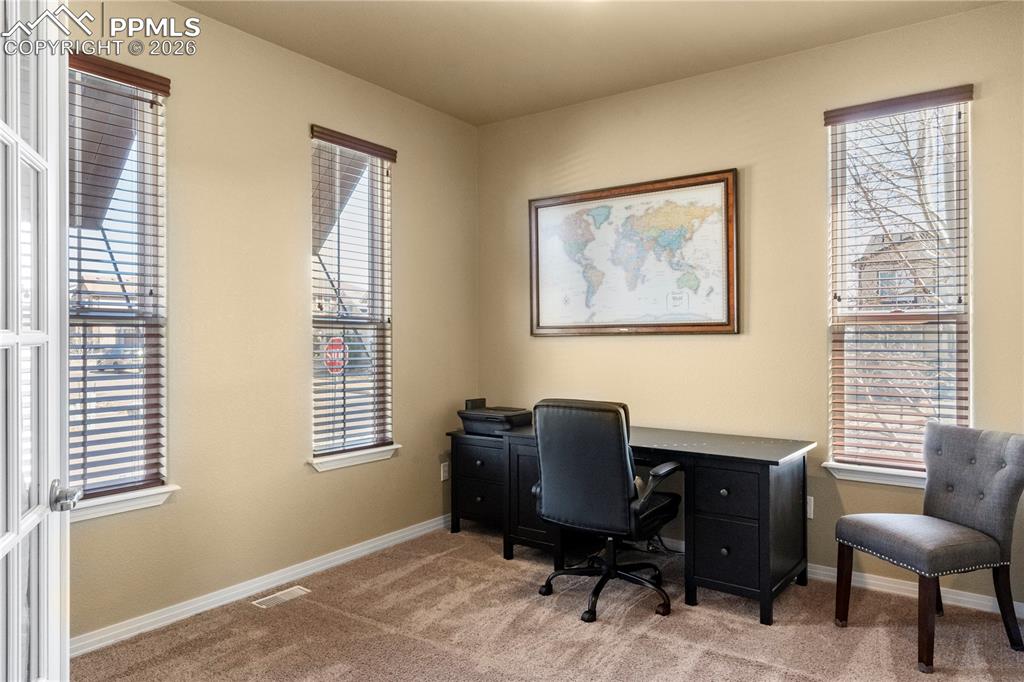 Just off the entry is the main level office with carpet and French doors. 