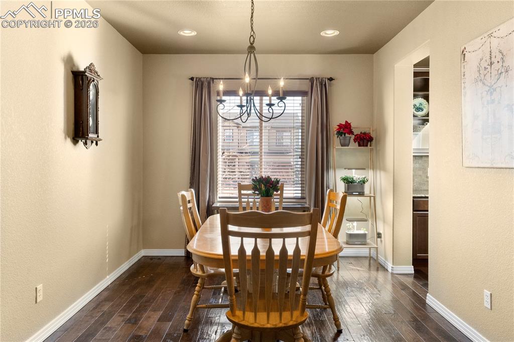 Formal dining room with wood flooring open to butlers pantry for easy entertaining. 