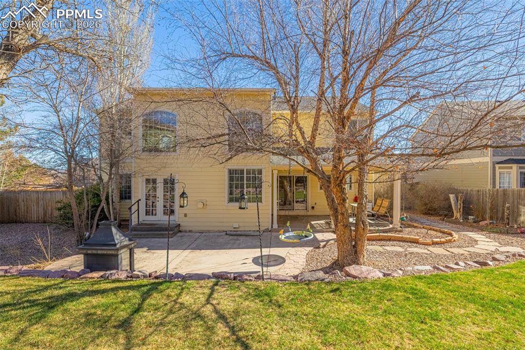 Well maintained lawn with xeroscape accents; patio has built in fireplace