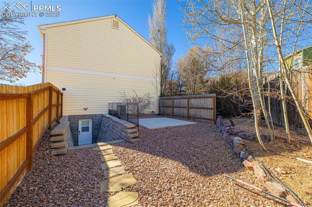 Basement level mother-in-law casita offers a private entrance, with patio and fenced off from main house backyard.