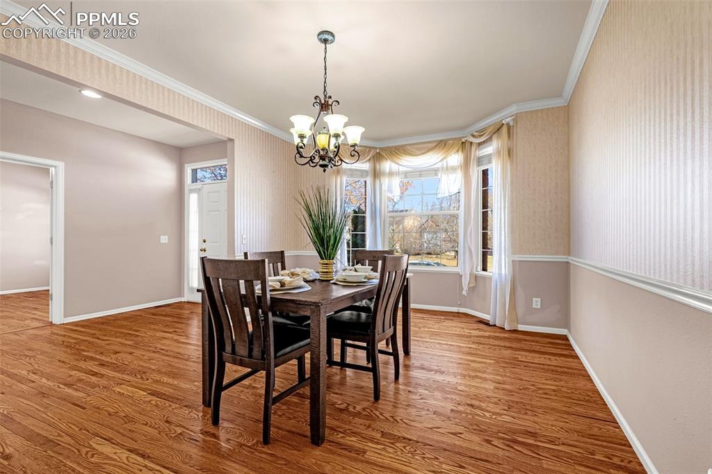 Formal dining area spaciously can accommodate large table and sidebar furnishings
